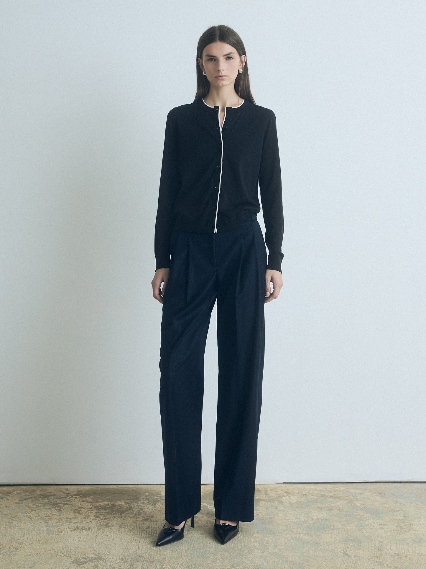 Woman wearing a black outfit with a white background