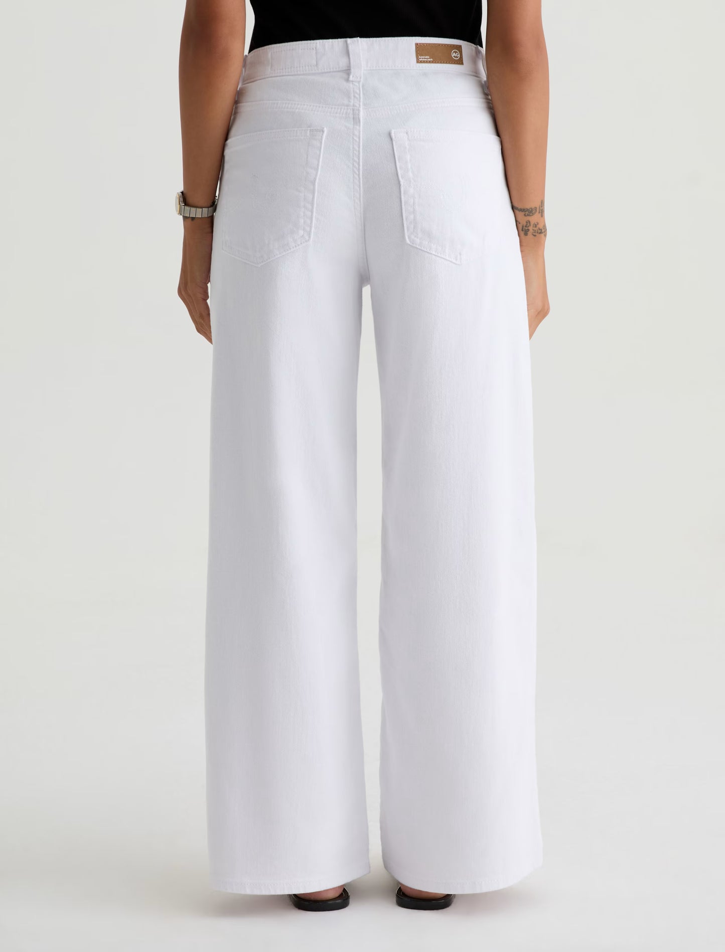 White wide-leg pants worn by a person on a white background