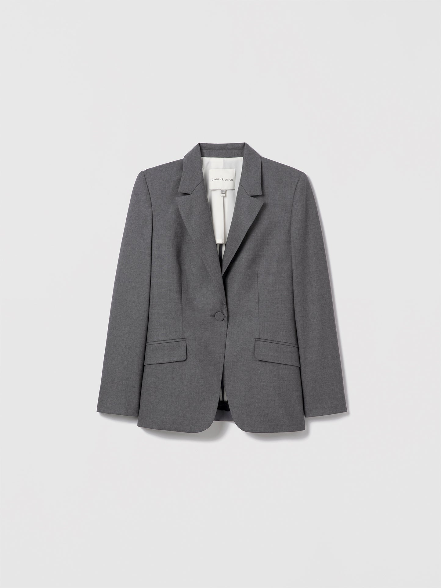 Grey melange single-breasted jacket in superfine wool by Loro Piana, cut in a classic semi-fitted silhouette with peak lapel, flap pockets, and single back vent. Fully lined. Made in Canada with Italian fabric. Lexi Jacket, style 696-1976 by Judith & Charles
