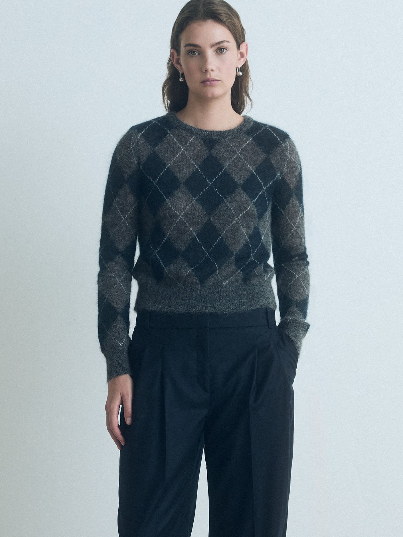 Woman wearing a Judith & Charles charcoal combo mohair sweater and navy judith and charles pants against a plain background