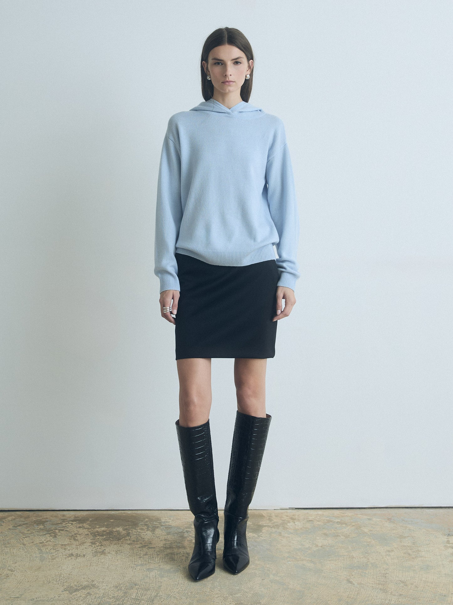 Model wearing Judith & Charles long-sleeve hooded sweater in sky blue Italian merino-cashmere, featuring a relaxed true-to-size fit.