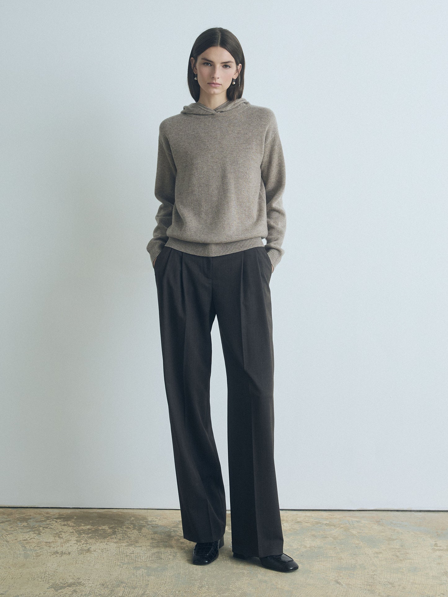 Model wearing Judith & Charles long-sleeve hooded sweater in taupe melange Italian merino-cashmere, featuring a relaxed true-to-size fit.