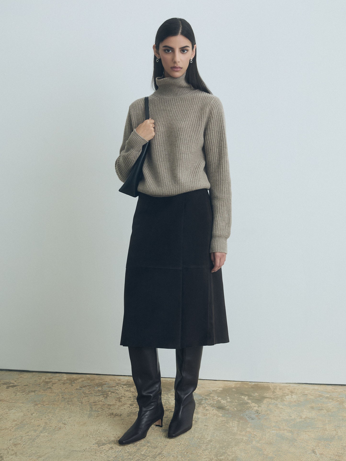 Model wearing wrap skirt in 100% chocolate suede, unlined and made in Turkey with taupe turtle neck 