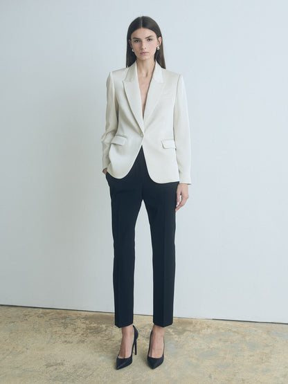 Model wearing judith and charles classic fit satin jacket in cream with peak lapel, flap and chest pockets, and back vent