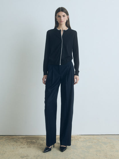 Woman wearing a navy pant with a white background