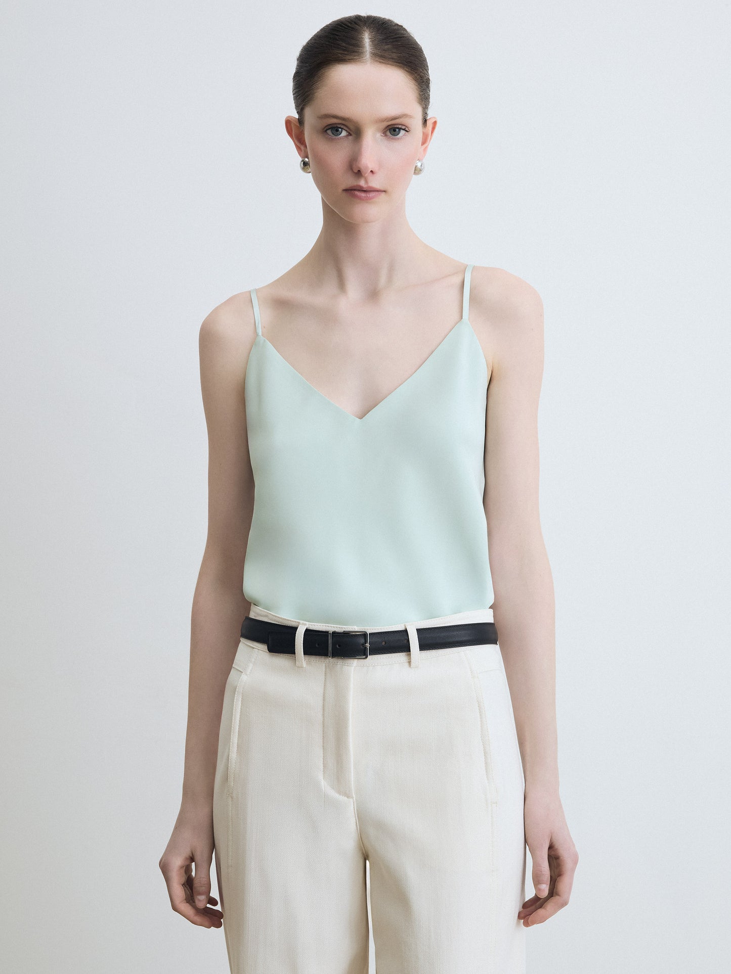 Mint blouse paired with beige pants