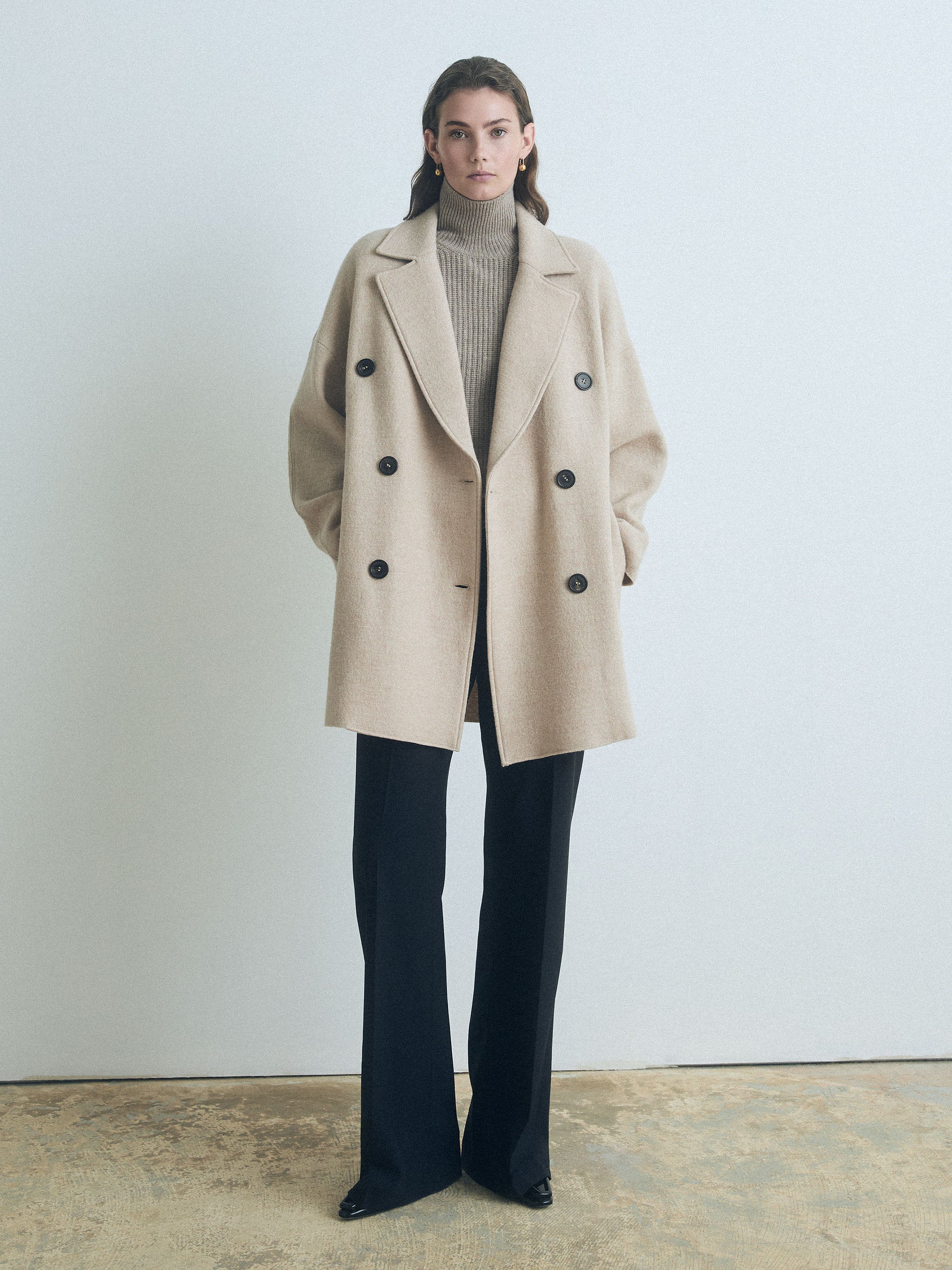 Woman wearing a Judith & Charles wheat-colored double-breasted boiled wool coat, made in Canada.