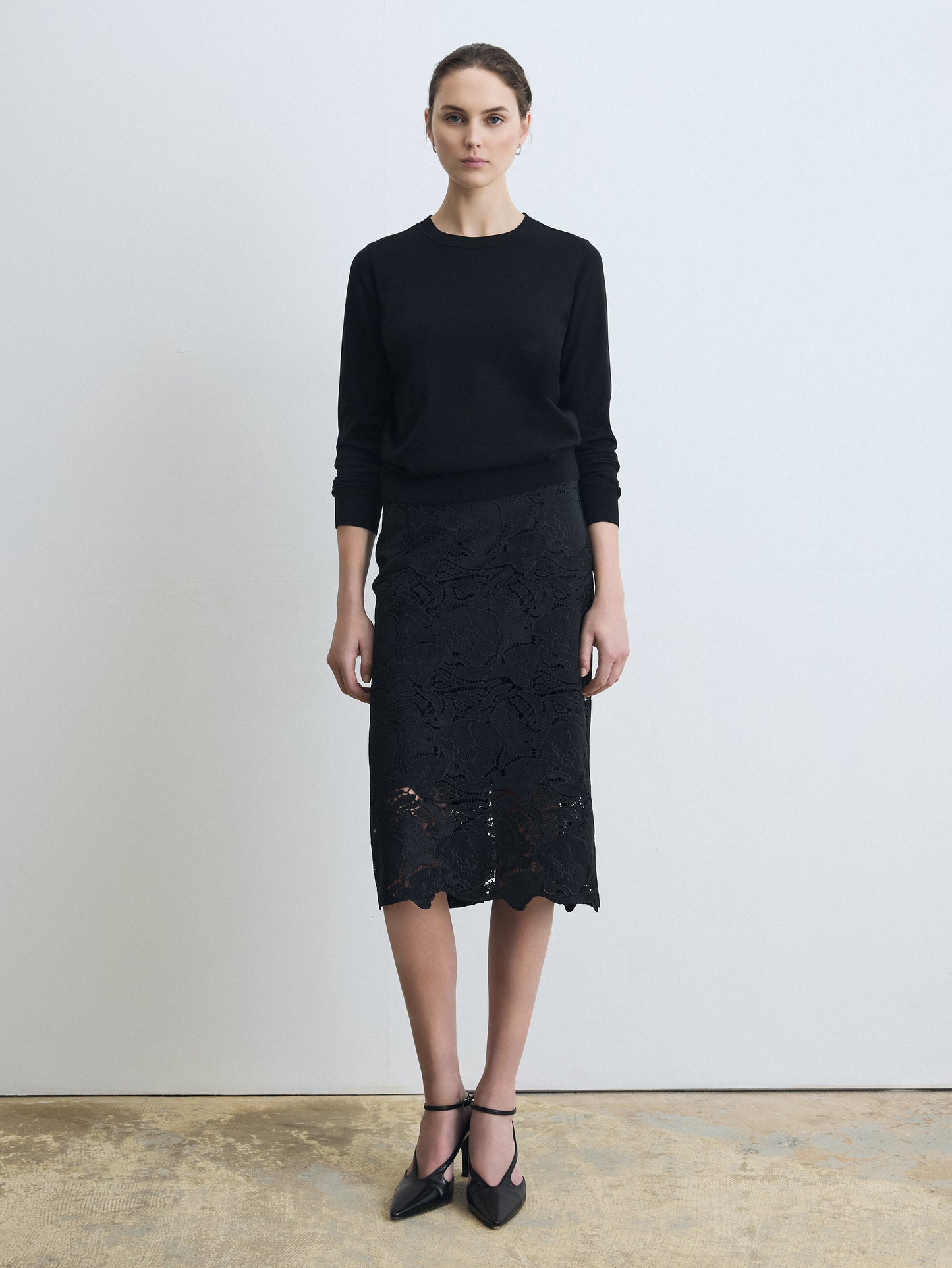 Woman wearing a clean, fully lined floral lace skirt  on a white background. 