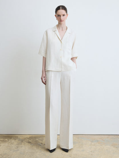 Person wearing a white outfit with a plain background
