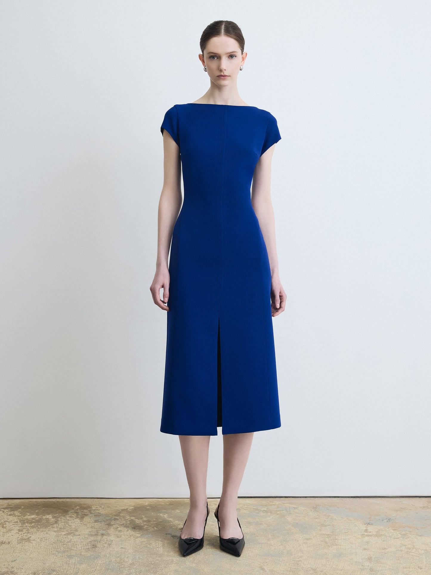 Woman wearing a blue dress against a plain background