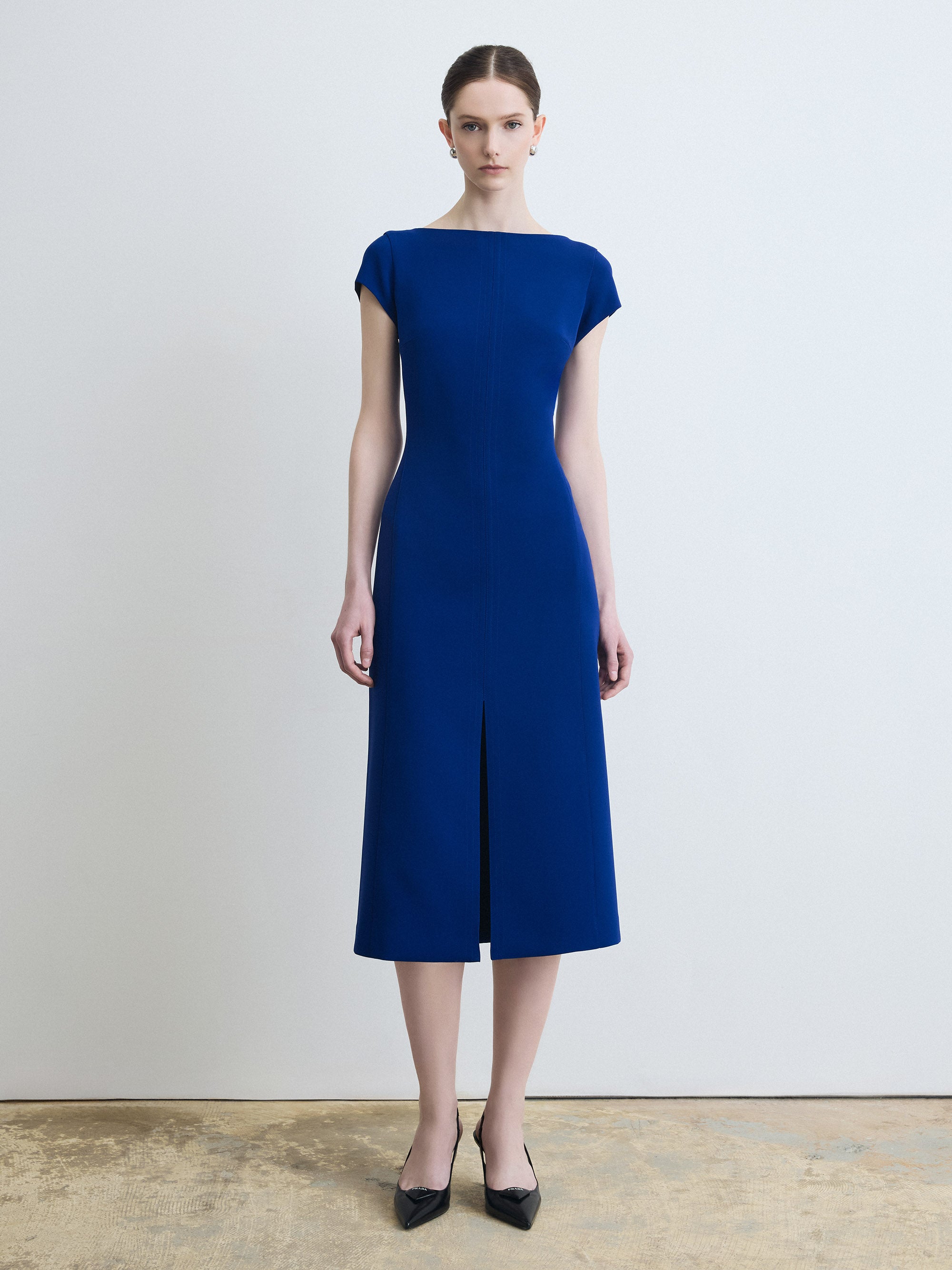 Woman wearing a blue dress against a plain background