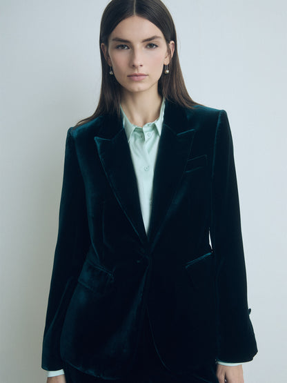 Model wearing emerald classic fit 1-button velvet jacket with peak lapel, flap and chest pockets, fully lined, made in Portugal from Italian fabric