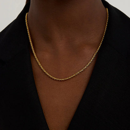 Woman wearing a gold necklace