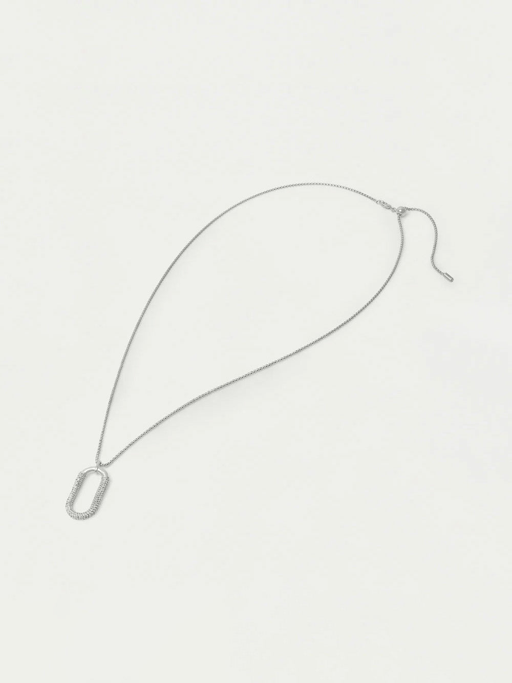 Silver necklace on a light gray background