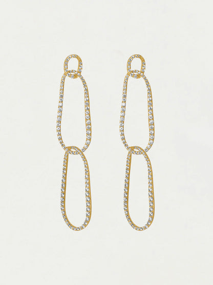 Gold chain earrings with clear gemstones on a light gray background