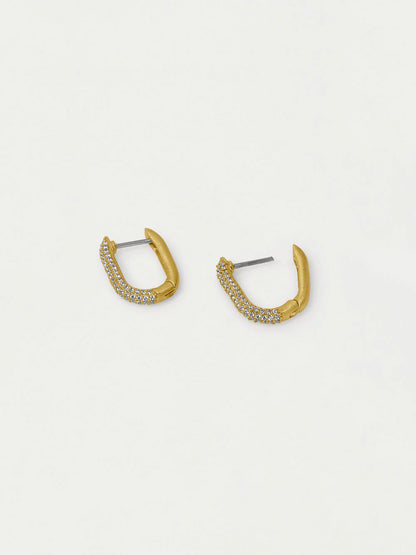 Gold hoop earrings with small stones on a light gray background