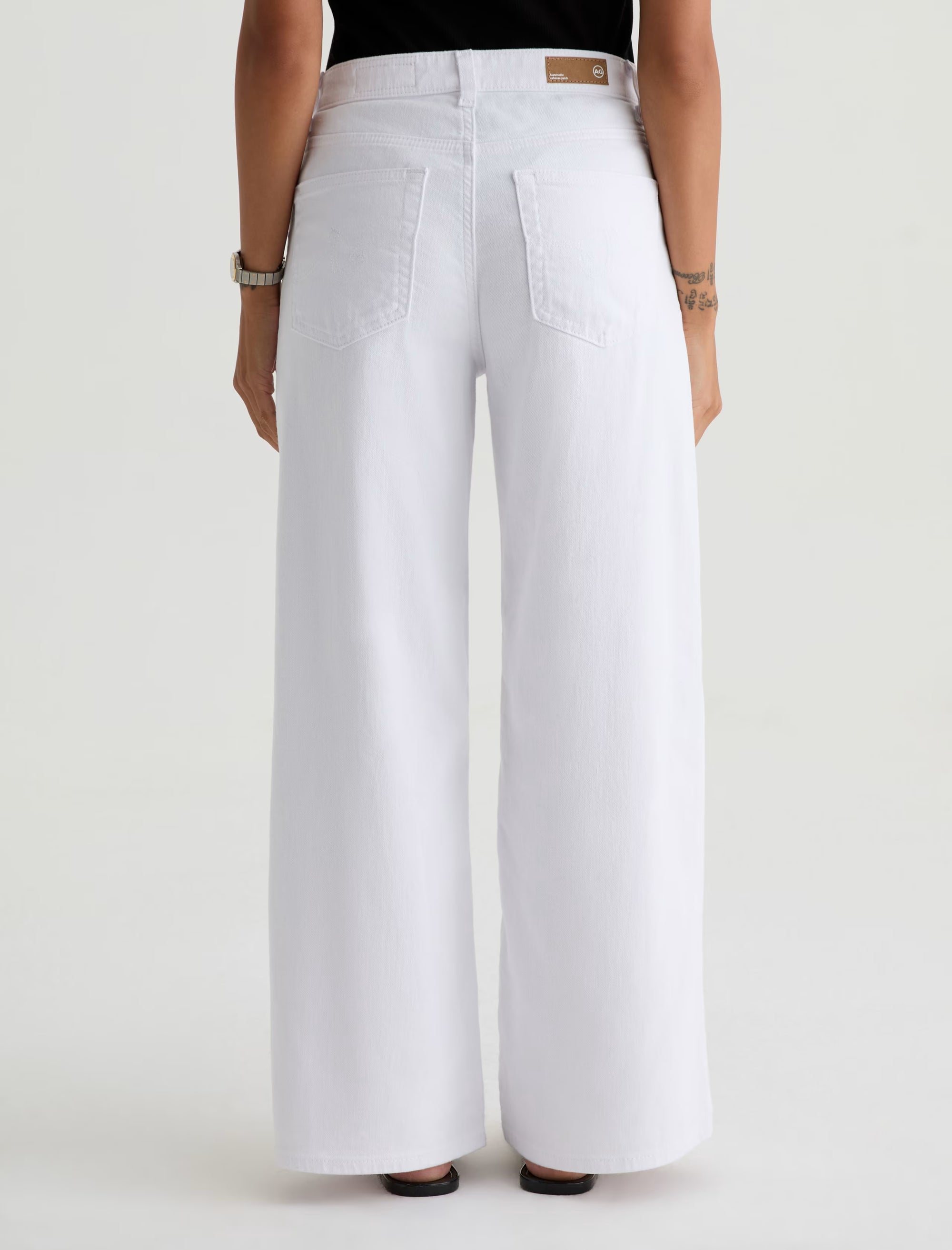 White wide-leg pants worn by a person on a white background