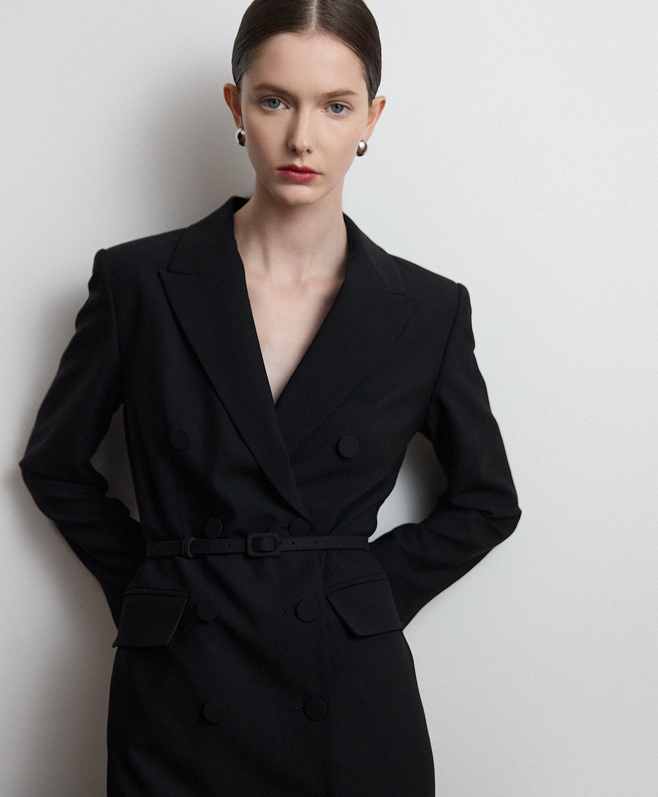 Woman wearing Judith & Charles DB suit dress against a plain background
