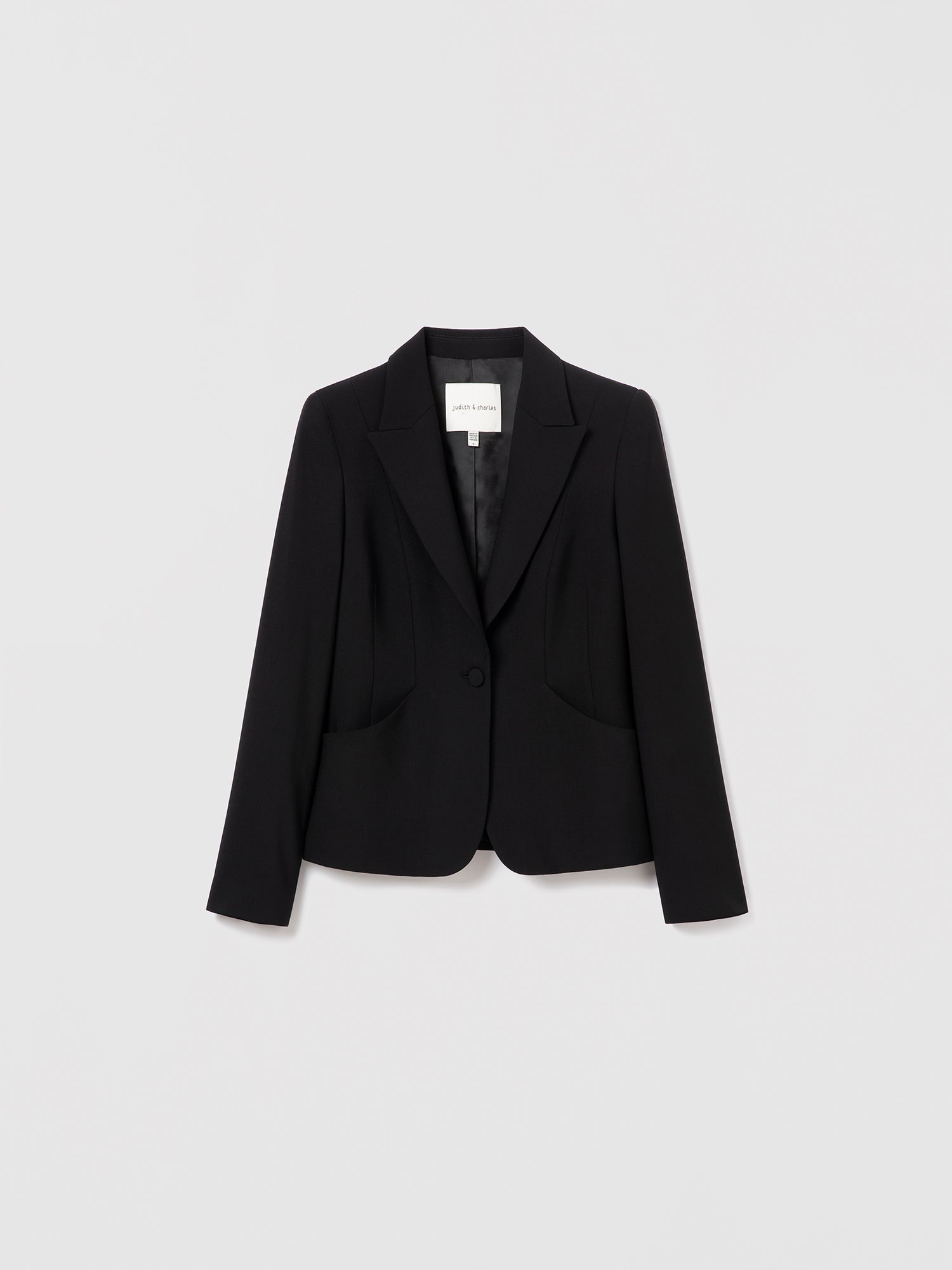 Black single-breasted wool jacket by Judith & Charles, fully lined with a tailored fit. Made from stretch virgin wool with a viscose lining.