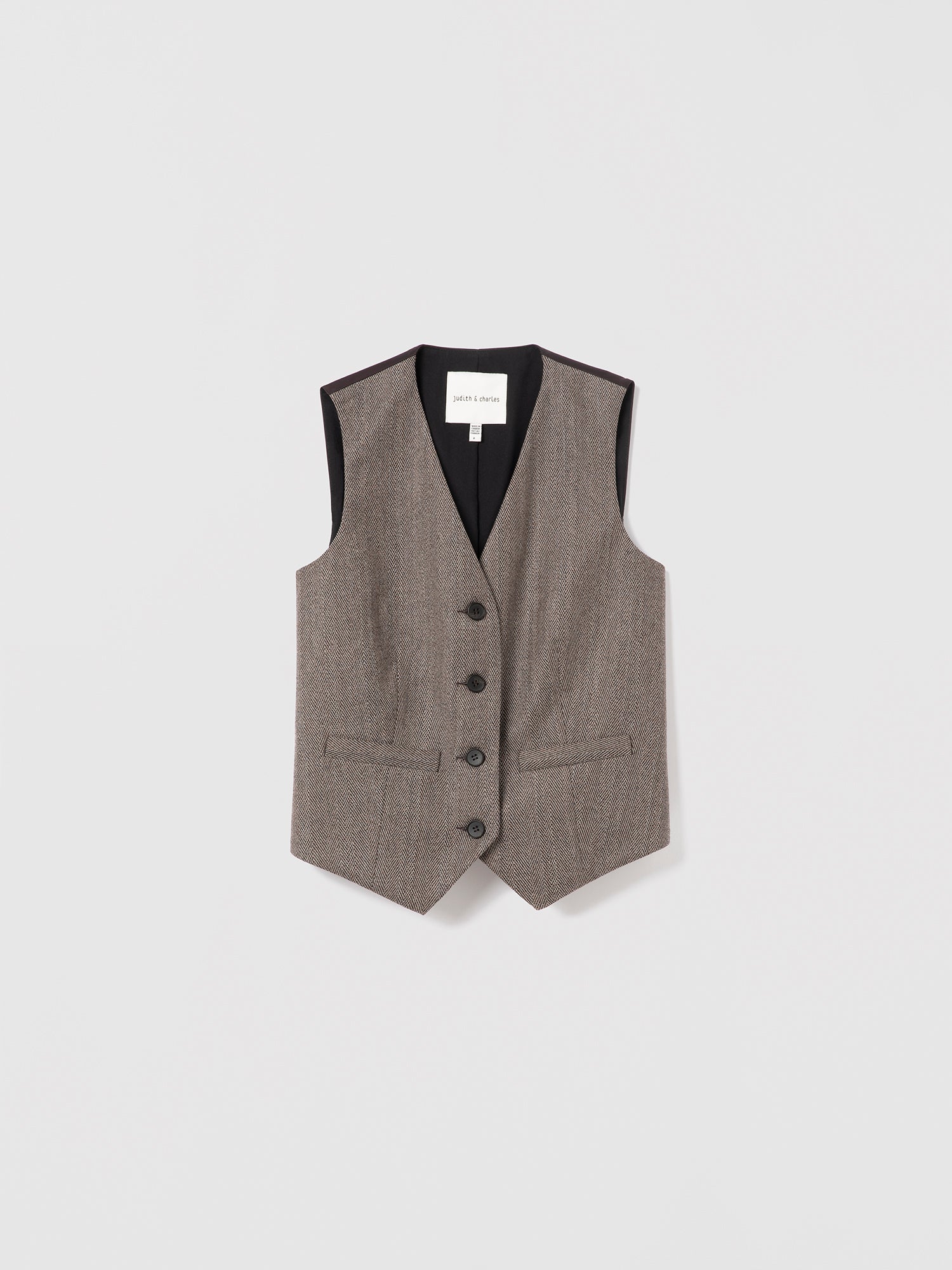 Taupe sleeveless tailored herringbone flannel vest by Judith & Charles, featuring welt pockets and a satin back.