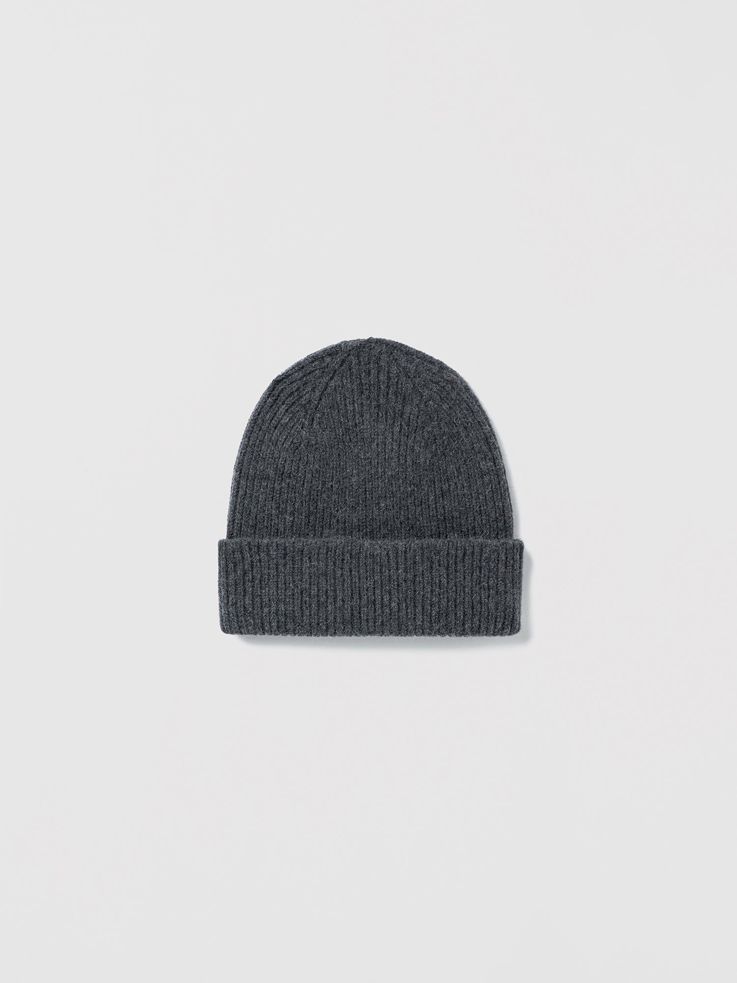 Flat lay of ribbed graphite beanie in soft lambswool and Caregora blend, classic silhouette in wool knit, made in Scotland