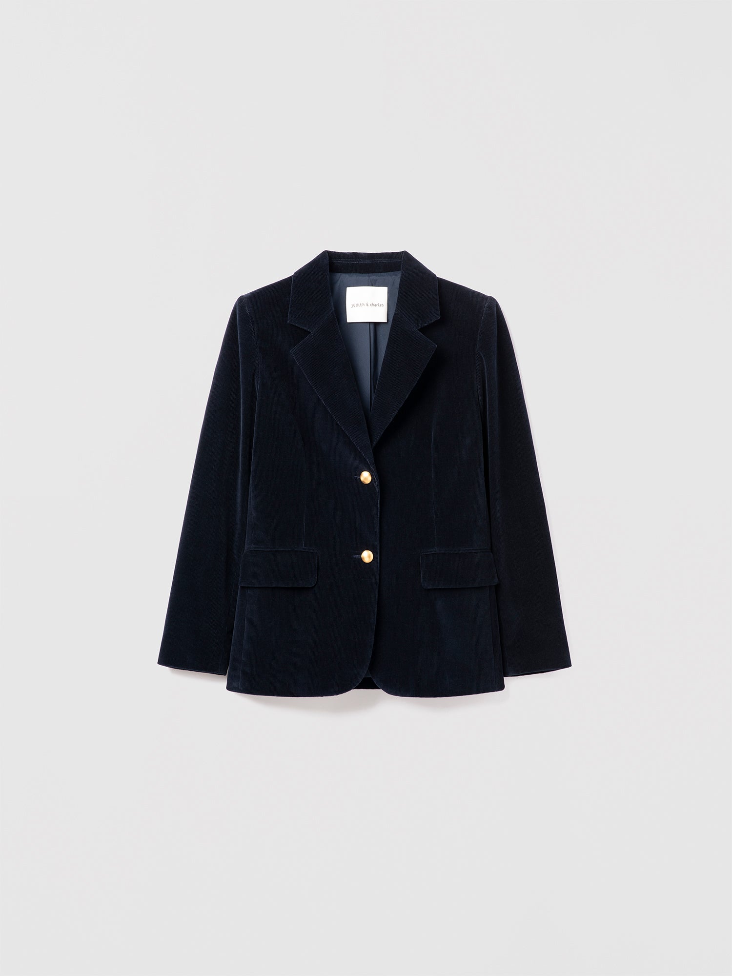 Judith & Charles navy stretch corduroy jacket with notch lapel, gold button closure, front flap pockets, and sleeve vents. Fully lined.
