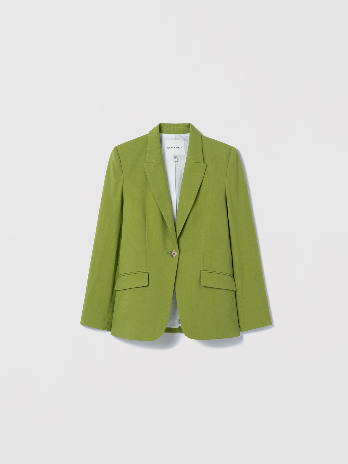 Green blazer on a light gray background