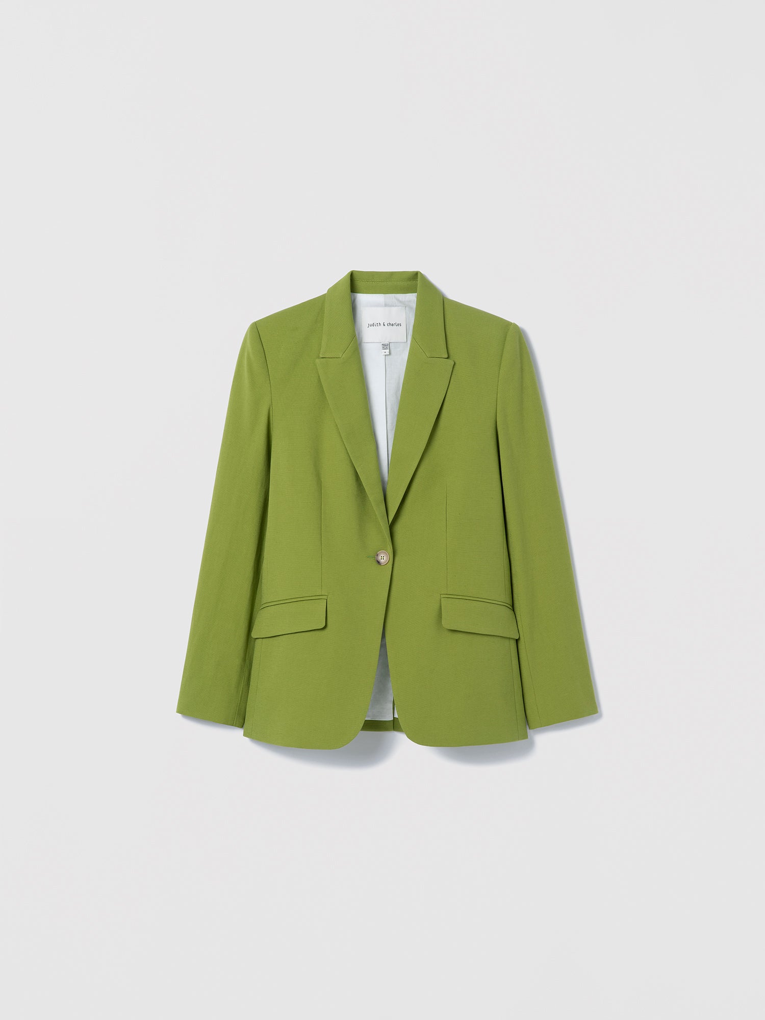 Green blazer on a light gray background