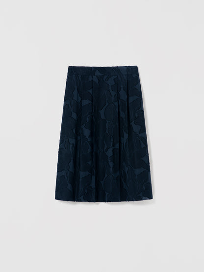 Navy blue skirt with geometric pattern on a light gray background
