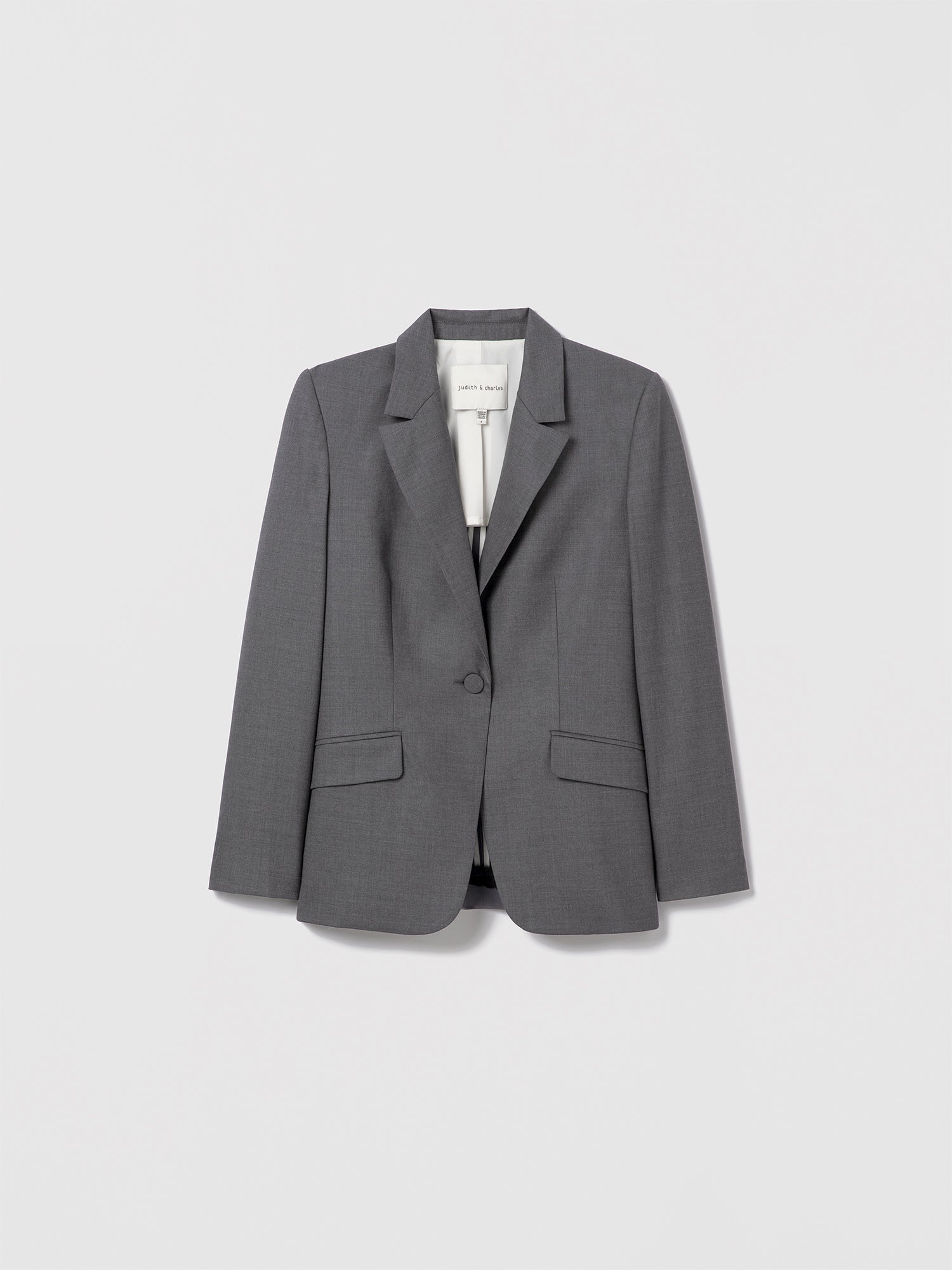 Grey melange single-breasted jacket in superfine wool by Loro Piana, cut in a classic semi-fitted silhouette with peak lapel, flap pockets, and single back vent. Fully lined. Made in Canada with Italian fabric. Lexi Jacket, style 696-1976 by Judith & Charles