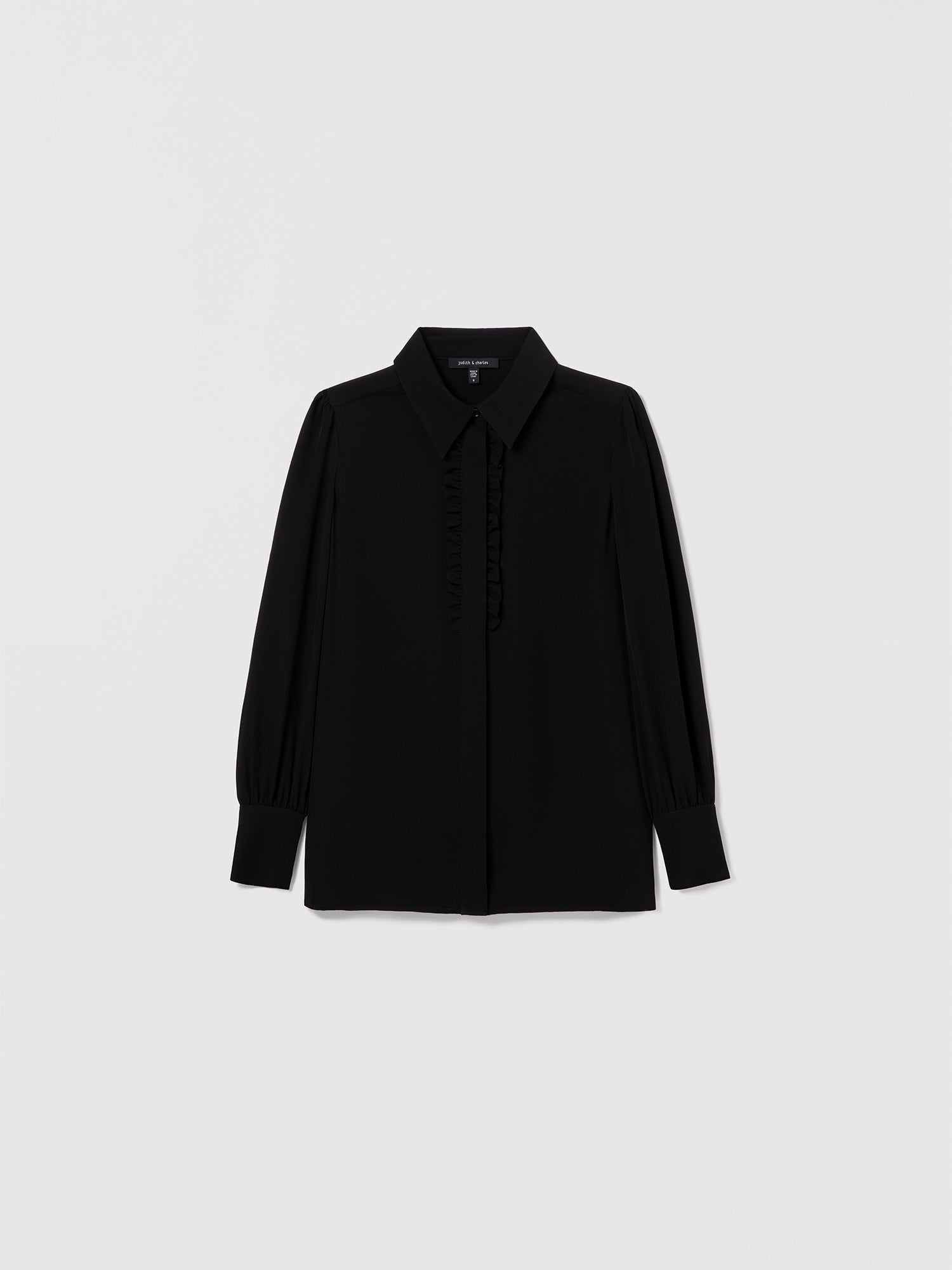 Black silk blouse by Judith & Charles featuring a shirt collar, hidden button placket, and double-layer ruffle detail at the front.