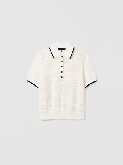 White sweater polo with navy trim on a light gray background