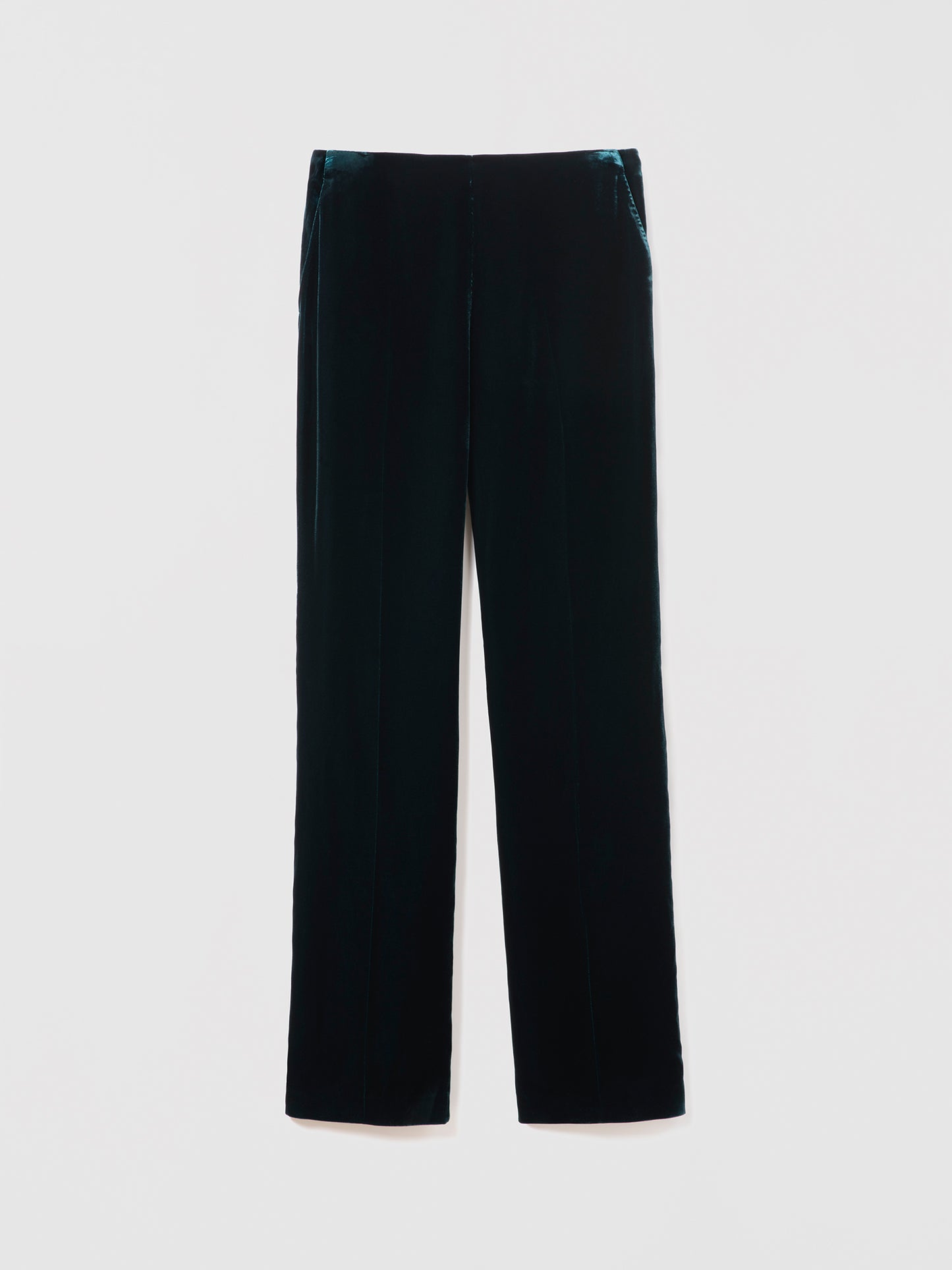 Emerad velvet pants on a light gray background