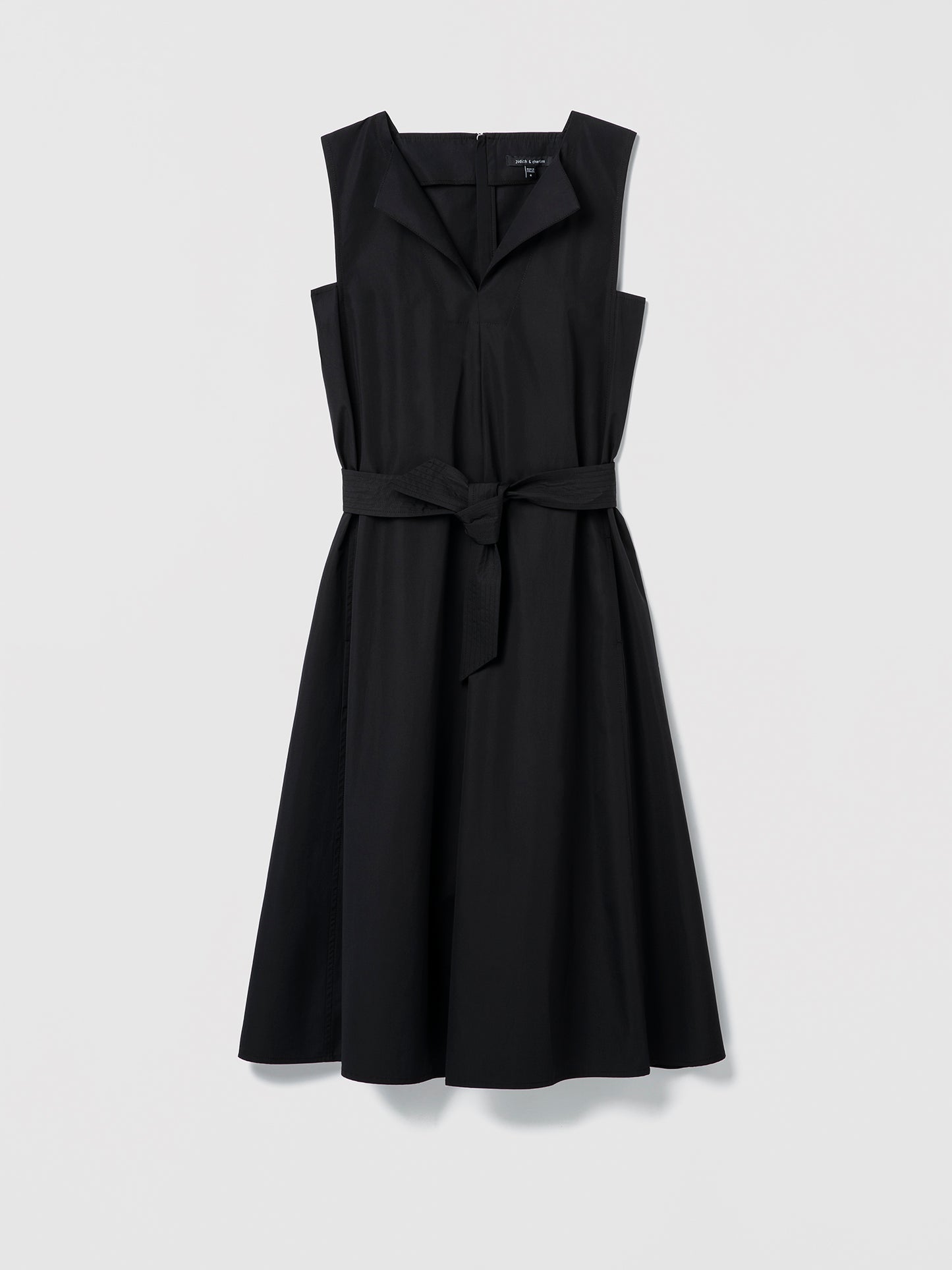 Black sleeveless dress with a belt on a light gray background