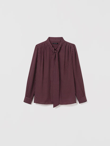 Judith & Charles cherry dot silk blouse with long sleeves, pleats, and neck tie. Straight fit, unlined, with button closure.